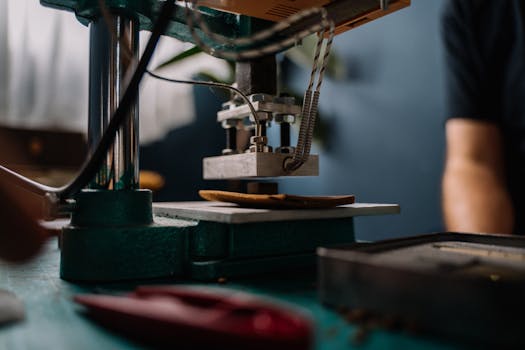Detailed view of a leather press machine in use, crafting in a workshop setting.